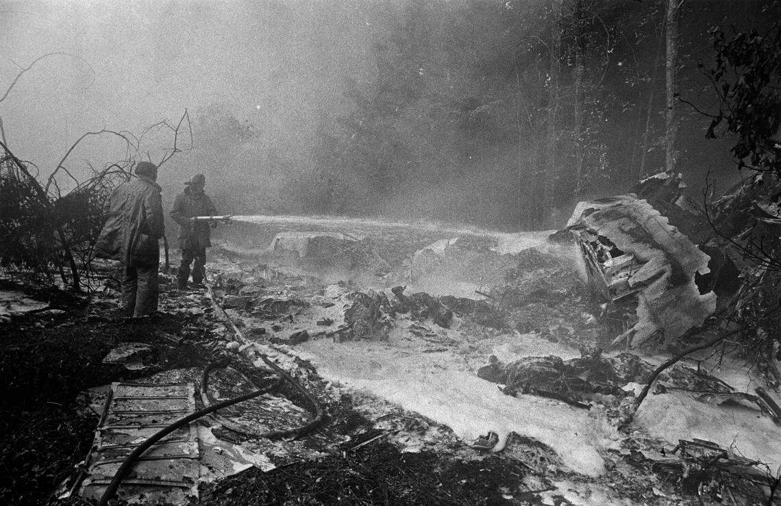 Firefighters spray the smoldering wreckage of Flight 212.
