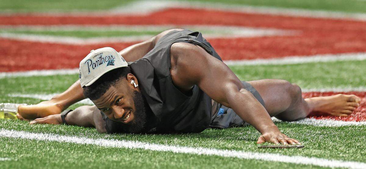 Carolina Panthers linebacker Brian Burns stretches on the turf of the Mercedes-Benz Stadium field in Atlanta, GA on Sunday, September 10, 2023. Burns and the Panthers open the NFL season against the Atlanta Falcons.