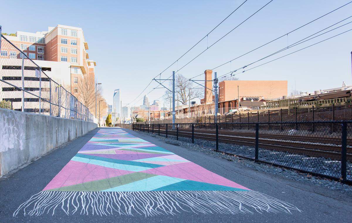 Magic Carpet, a ground mural along the light rail line, can be found at 2161 Hawkins St.