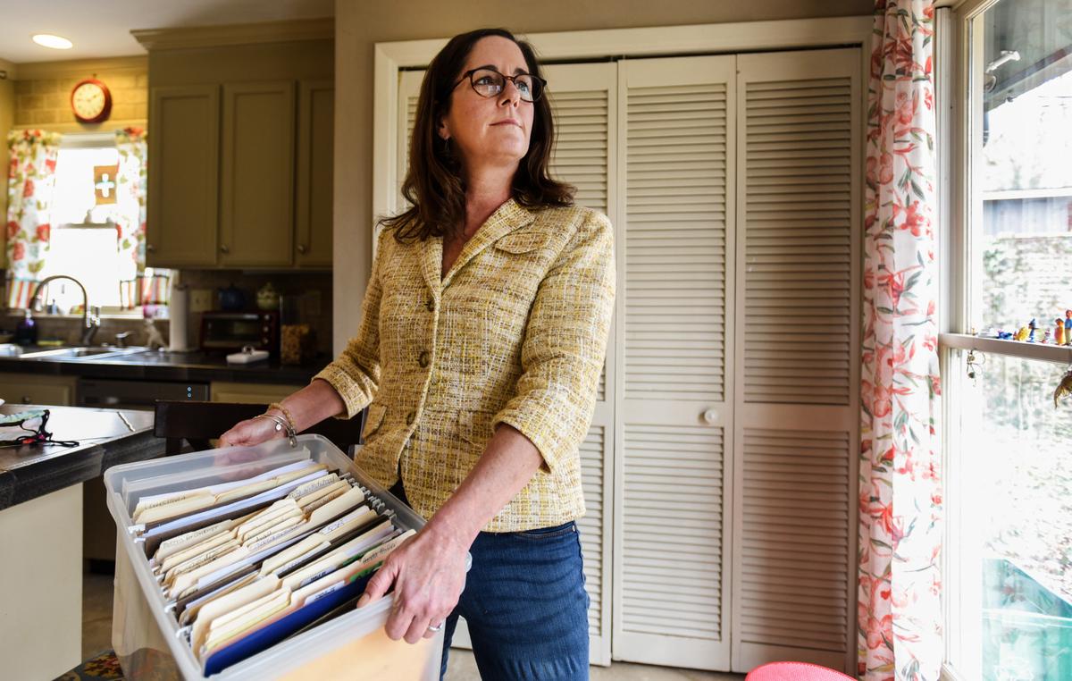 Audra Toussaint holds a box of files related to her domestic abuse case in Charlotte, NC, on Tuesday, March 2, 2021. With the help of a family justice center, she could have gathered most of this information in one place.