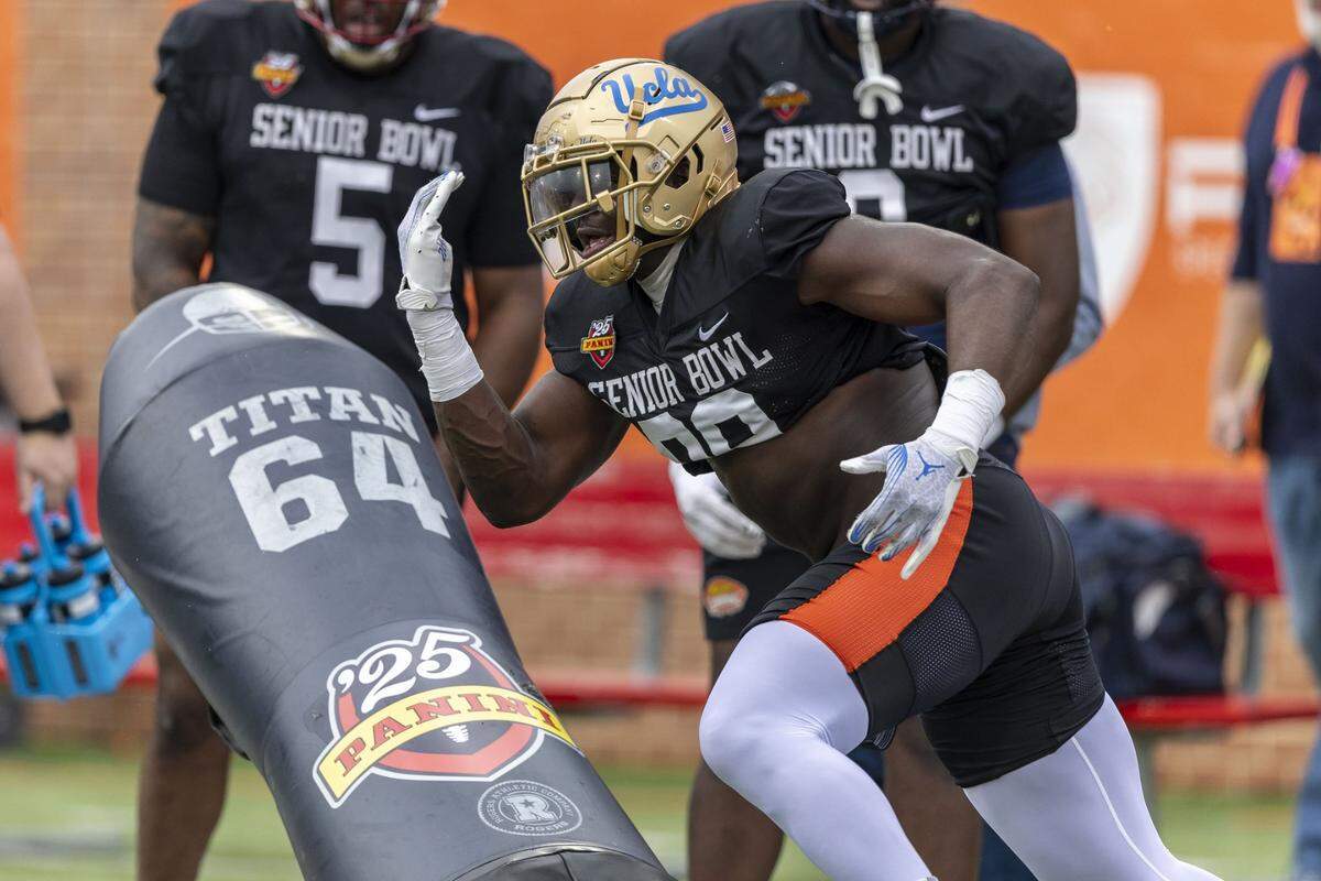 Jan 30, 2025; Mobile, AL, USA; National team defensive lineman Oluwafemi Oladejo of UCLA (99) works through drills during Senior Bowl practice for the National team at Hancock Whitney Stadium. Mandatory Credit: Vasha Hunt-Imagn Images