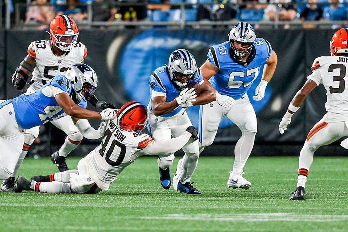 Carolina Panthers running back Raheem Blackshear runs with the ball as Cleveland Browns left back Nathaniel Watson tackles him during the preseason game between the Cleveland Browns and the Carolina Panthers at Bank of America Stadium in Charlotte, NC, Friday August 8, 2025.
