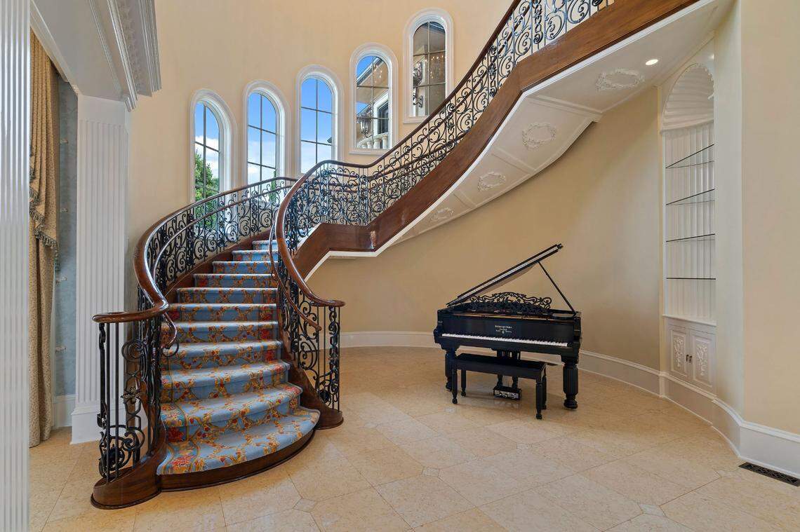 A suspended staircase leads to the upper level of Robert and Sonya Stevanovski’s 15,000-square-foot Lake Norman mansion.  