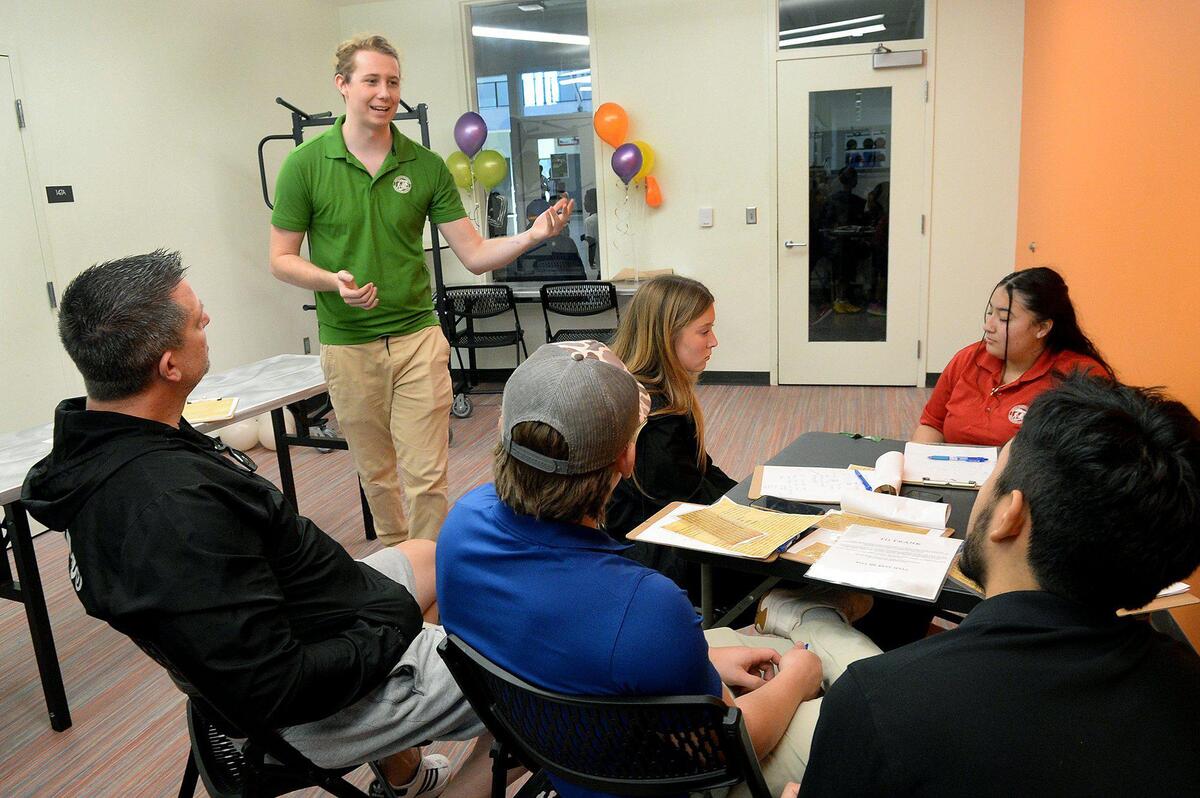 Jack Hindle (standing), 24, a senior aquatic specialist at the Eastway Regional Recreation Center, is the catalyst behind the idea to stage murder mystery events with clues posted around and in the lap pool at the center. Saturday, Dec. 07, 2024.