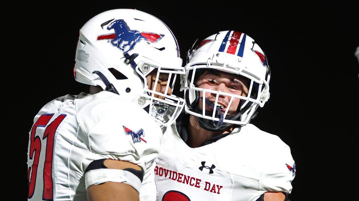 Providence Day’s Miles Funderburk, left and Brody Barnhardt, right, helped the Chargers beat Rabun Gap 34-27 Friday for the NCISAA state title