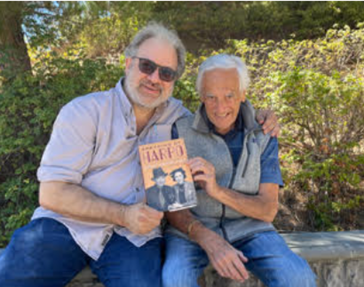 Marx Brothers historian Robert S. Sanders, left, and Bill Marx, son of Harpo Marx, holding a copy of his mother Susan’s book. Bader had collaborated on that book. Bill Marx was thrilled to team up with Bader on the “Harpo Speaks!” album project.
