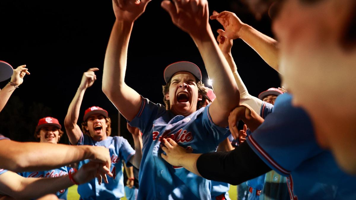 CHARLOTTE, NC - MAY 10: Charlotte Catholic Cougars #21 Dylan Kelleher celebrates with the team after defeating the Myers Park Mustangs in the second round of the NCHSAA baseball playoffs at Myers Park High School in Charlotte, NC on May 10, 2024.