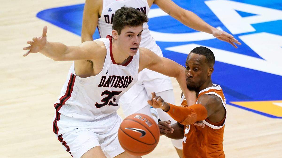 Texas guard Matt Coleman III (2) reaches for a loose ball against Davidson forward Luka Brajkovic (35) durinig the second half of an NCAA college basketball game in the Maui Invitational tournament, Monday, Nov. 30, 2020 in Asheville, N.C. Texas won 78-76. (AP Photo/Kathy Kmonicek)