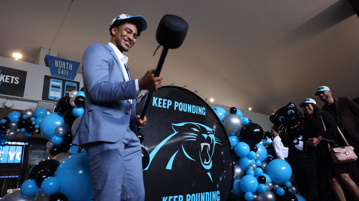 Carolina Panthers QB Bryce Young gets ready to bang the “Keep Pounding” drum before making his way into the Bank of America Stadium Friday morning, April 28, 2023.