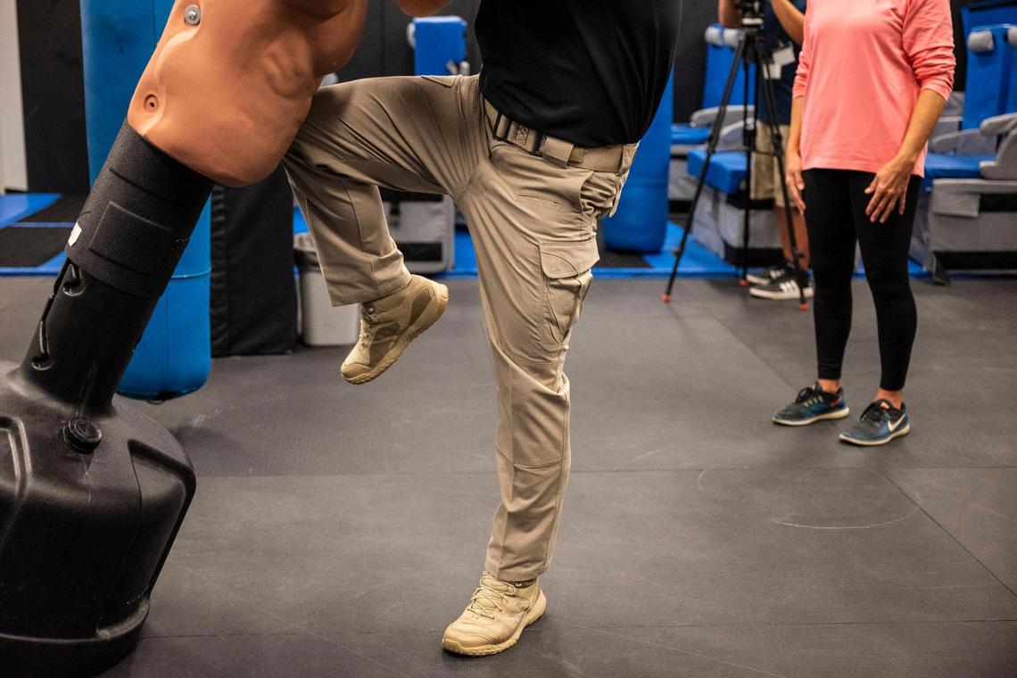 A Federal Air Marshal instructor demonstrates how to deliver a hit using his knee during a self defense training class at the Federal Air Marshal Service Charlotte Field Office.