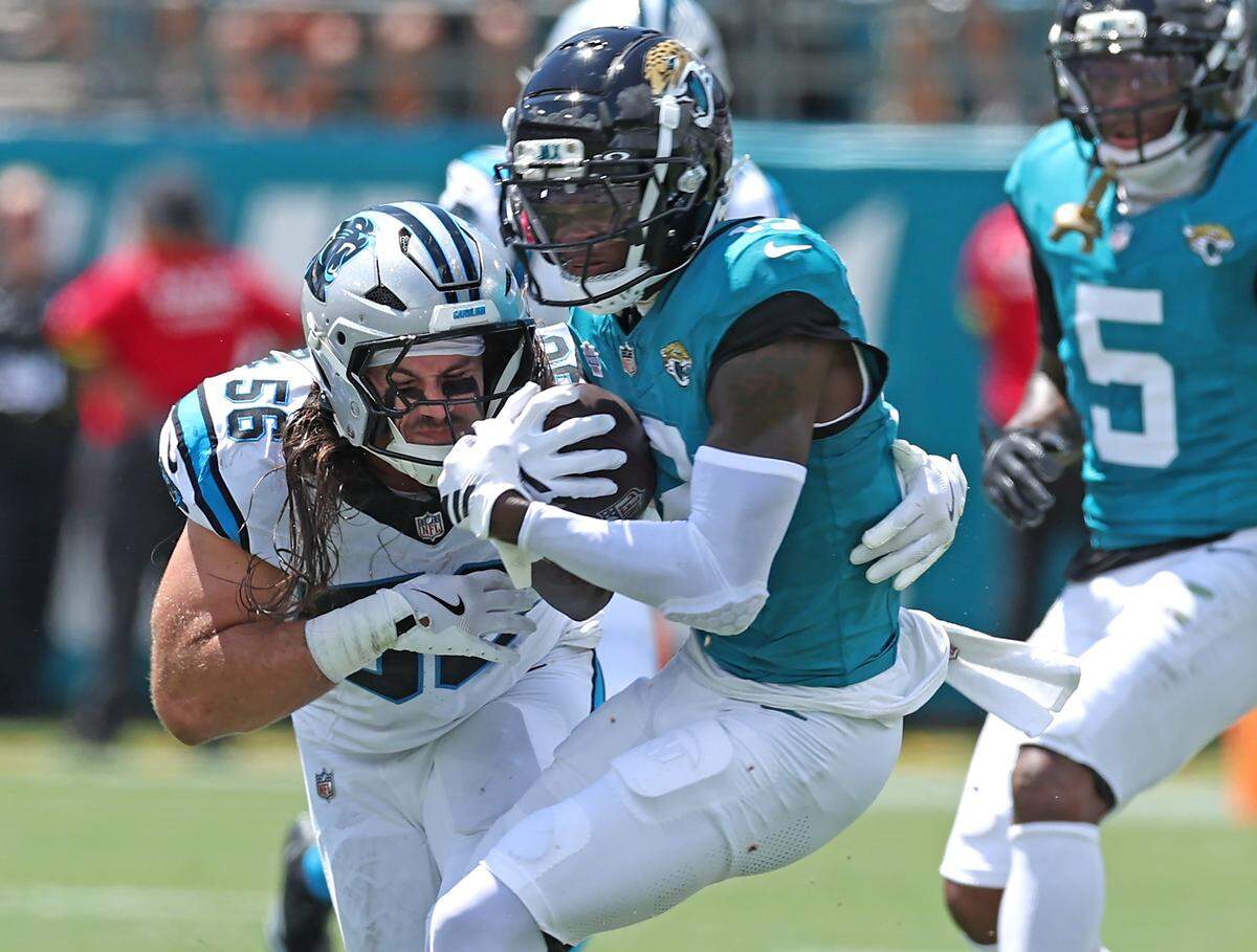 Carolina Panthers linebacker Christian Rozeboom, left, makes the tackle on Jacksonville Jaguars wide receiver Travis Hunter, right, during action on Sunday, September 7, 2025 at Everbank Stadium in Jacksonville, Florida.