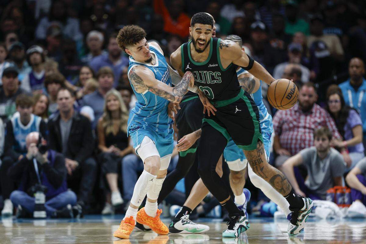 Boston Celtics forward Jayson Tatum (0) collides with Charlotte Hornets guard LaMelo Ball (1) during the second half at Spectrum Center. 