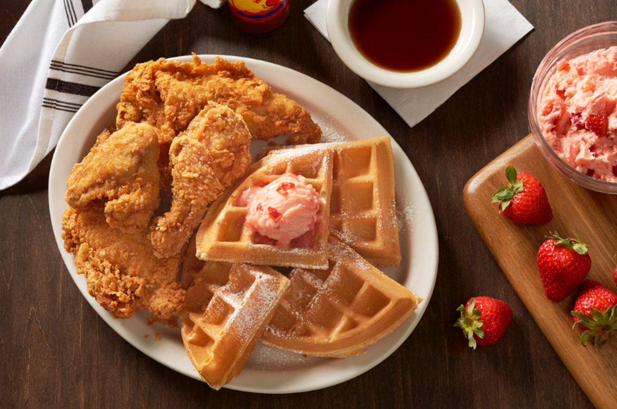 Metro Diner’s Fried Chicken & Waffles, topped with powdered sugar and strawberry butter.
