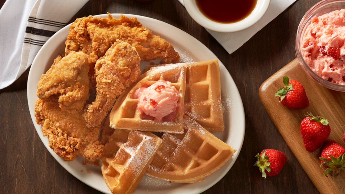 Metro Diner’s Fried Chicken & Waffles, topped with powdered sugar and strawberry butter.