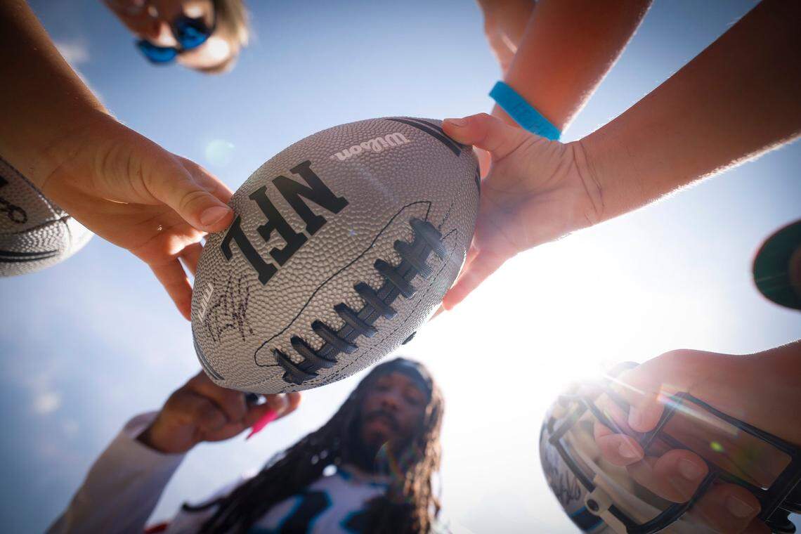 Carolina Panthers running back D’Onta Foreman (33) signs autographs for fans after the teams training camp practice at Wofford College in Spartanburg, S.C., Thursday, July 28, 2022.