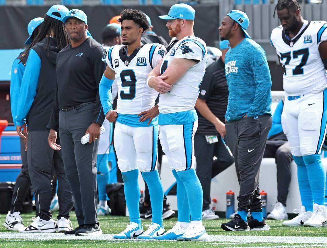 Carolina Panthers quarterbacks Bryce Young, center and Andy Dalton, right, stand along the team’s sideline in the closing moments of action against the Los Angeles Chargers on Sunday, September 15, 2024 at Bank of America Stadium in Charlotte, NC. The Chargers defeated the Panthers 26-3.