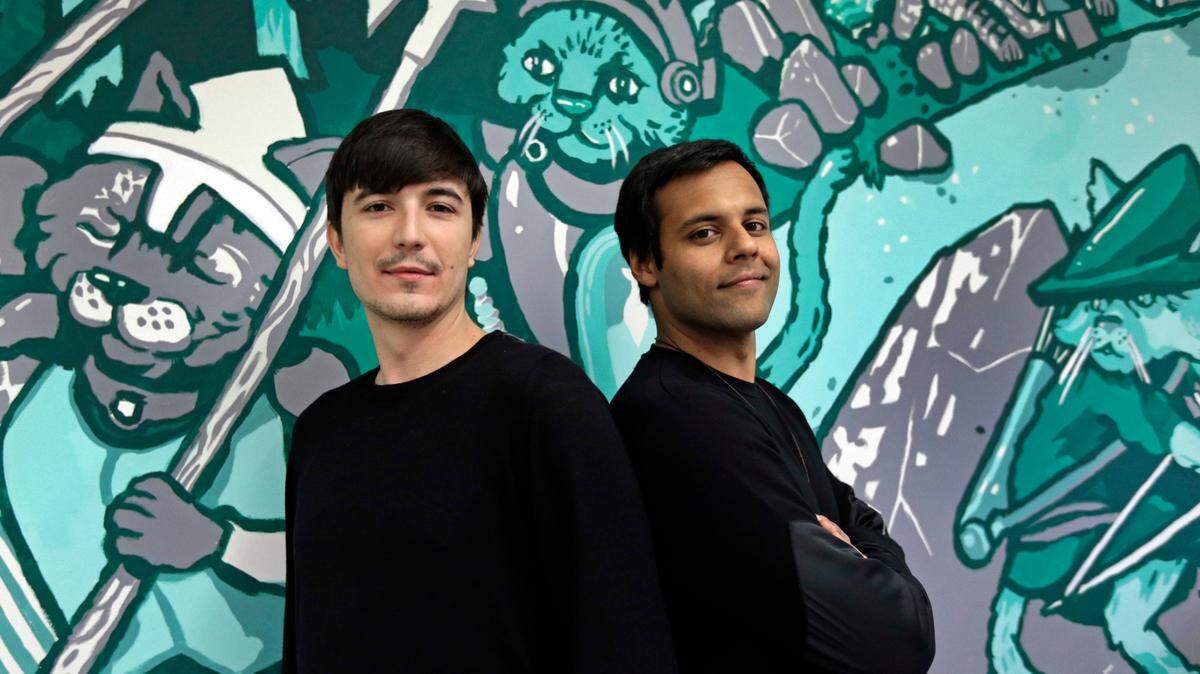 Robinhood co-founders Vlad Tenev, left, and Baiju Bhatt pose at company headquarters in Palo Alto, Calif. Robinhood is bringing hundreds of jobs as part of an expansion into Charlotte.