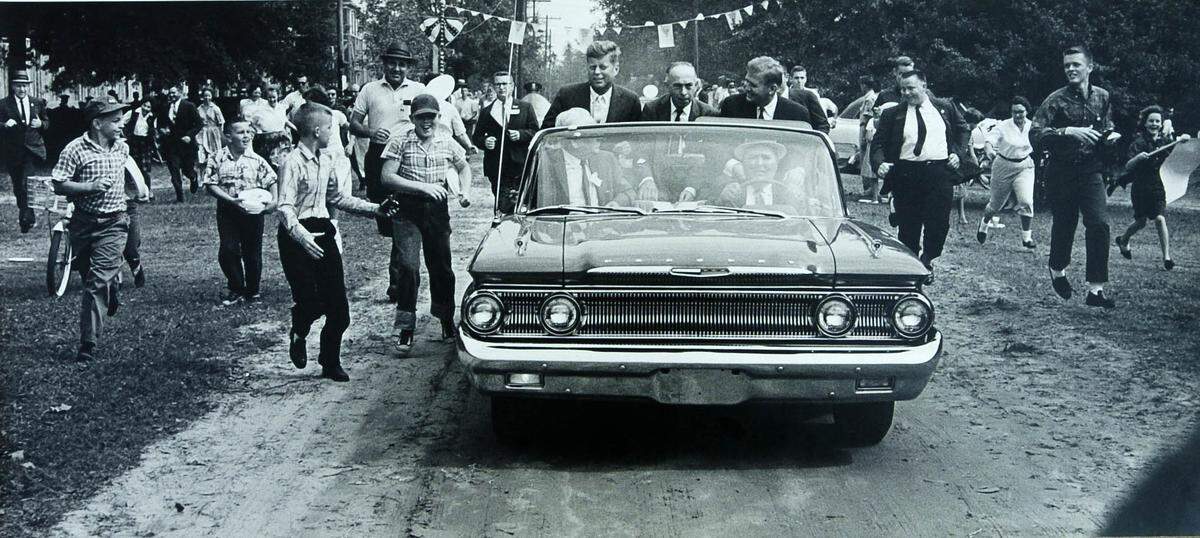 In a Don Sturkey photo, John F. Kennedy (before he was president) en route from the municipal airport to East Carolina University’s football stadium in Greenville, NC, in 1960.