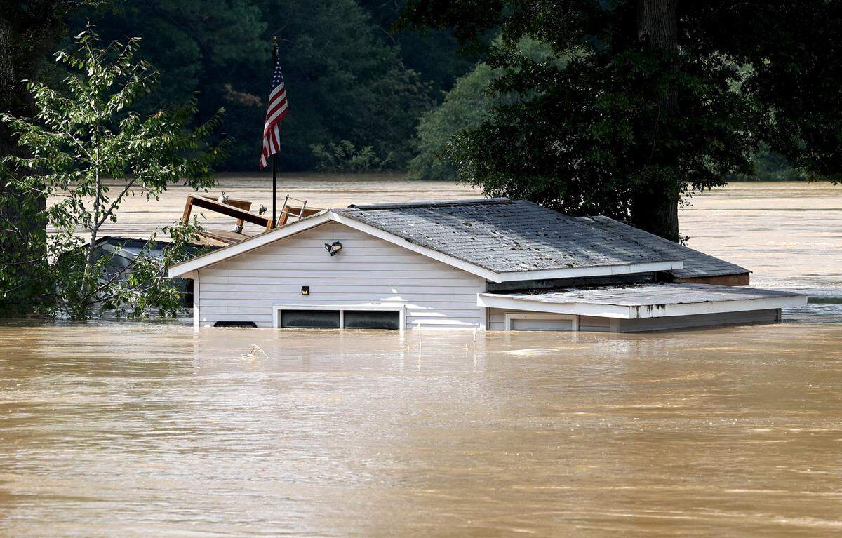 A small outer building is submerged in flood water from the Catawba River near the intersection of Lake Drive on Saturday, September 28, 2024.