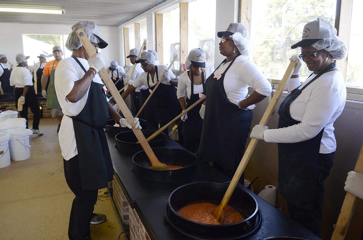 Left to right: Theadora Samuel Allison Ball, Drema Gaiten and Betty Staton stir Brunswick stew at the 84th annual Mallard Creek Barbecue on Thursday Oct. 24, 2013. The event brought thousands of people to the yearly right of passage where citizens not only can get their hands on a great slaw and pulled pork sandwich but also their local politicians who come out in force to campaign for election.