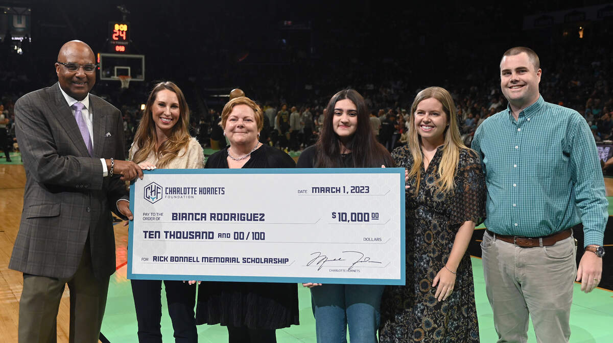 Bianca Rodriguez, fourth from left, is the winner of the Rick Bonnell Memorial Scholarship award. Rodriguez was presented with a $10,000 check during a timeout of the Charlotte Hornets vs. Phoenix Suns game at Spectrum Center on Feb. 1, 2023.