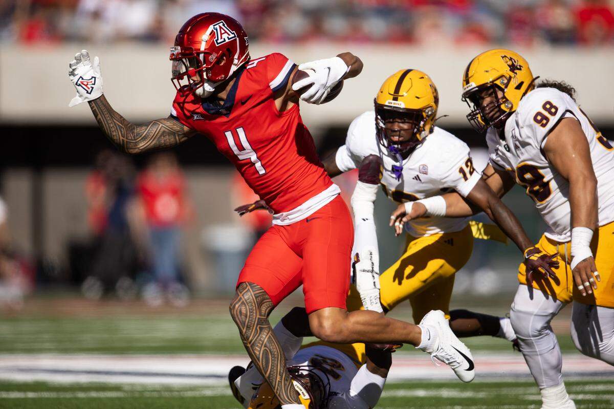 Nov 30, 2024; Tucson, Arizona, USA; Arizona Wildcats wide receiver Tetairoa McMillan (4) against the Arizona State Sun Devils in the first half during the Territorial Cup at Arizona Stadium. Mandatory Credit: Mark J. Rebilas-Imagn Images