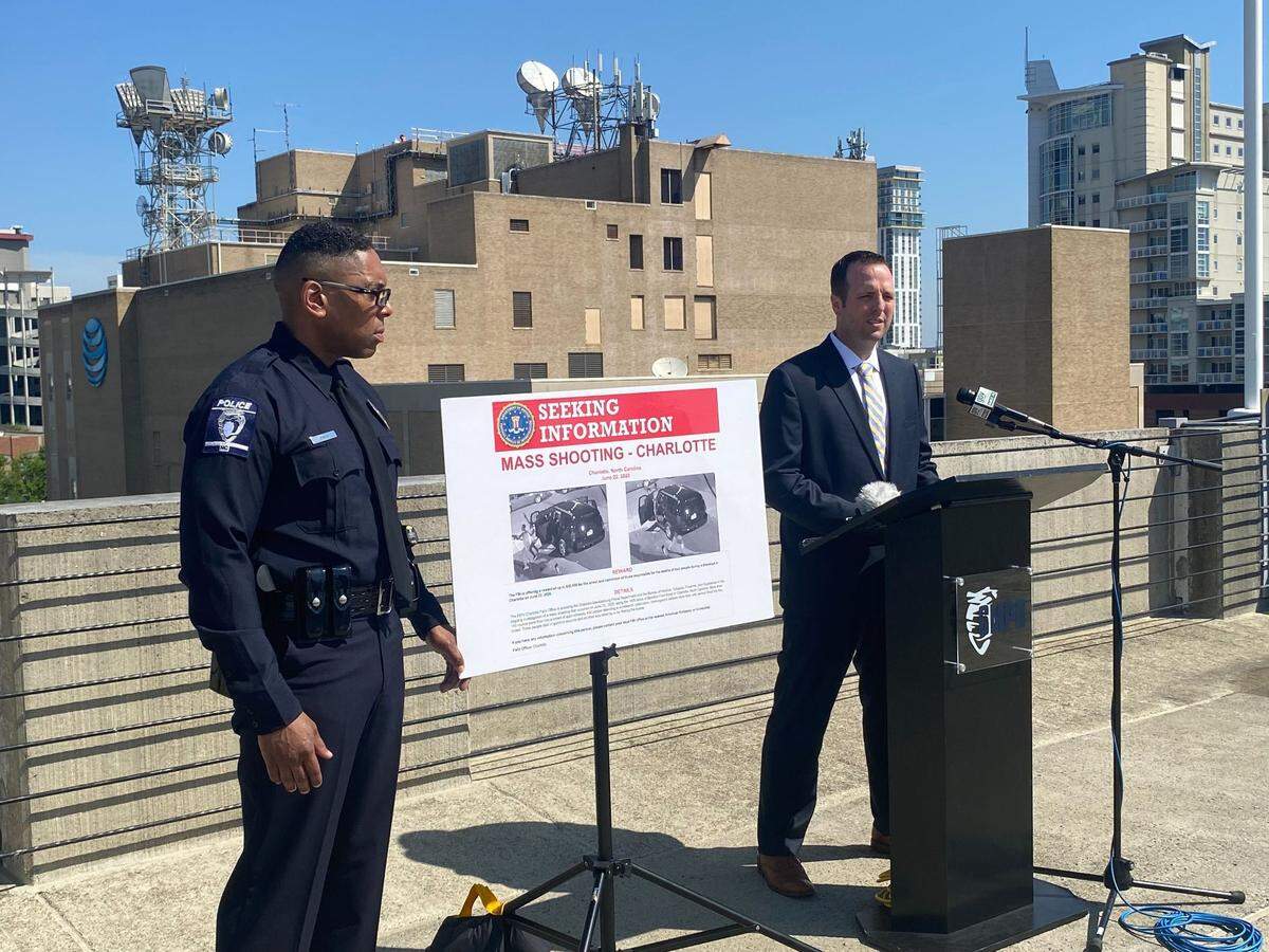 Charlotte-Mecklenburg Police Officer Ricky Smith stands next to Lt. Bryan Crum, right, during a news conference on Friday, June 17, 2022. Crum announced an increase in the reward money for tips that lead to arrests in the 2020 Juneteenth mass shooting on Beatties Ford Road. None have been made so far.