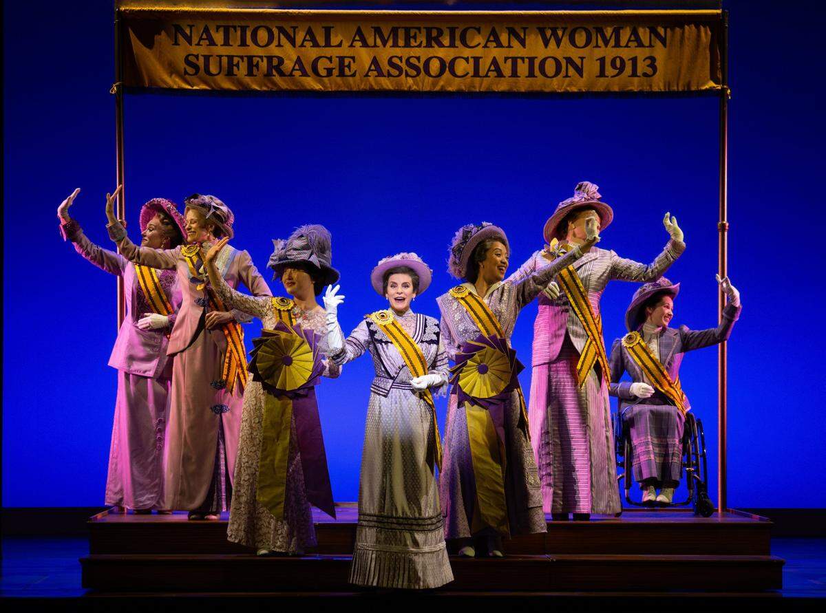 Jenn Colella as Carrie Chapman Catt, along with the company of “Suffs” on Broadway.