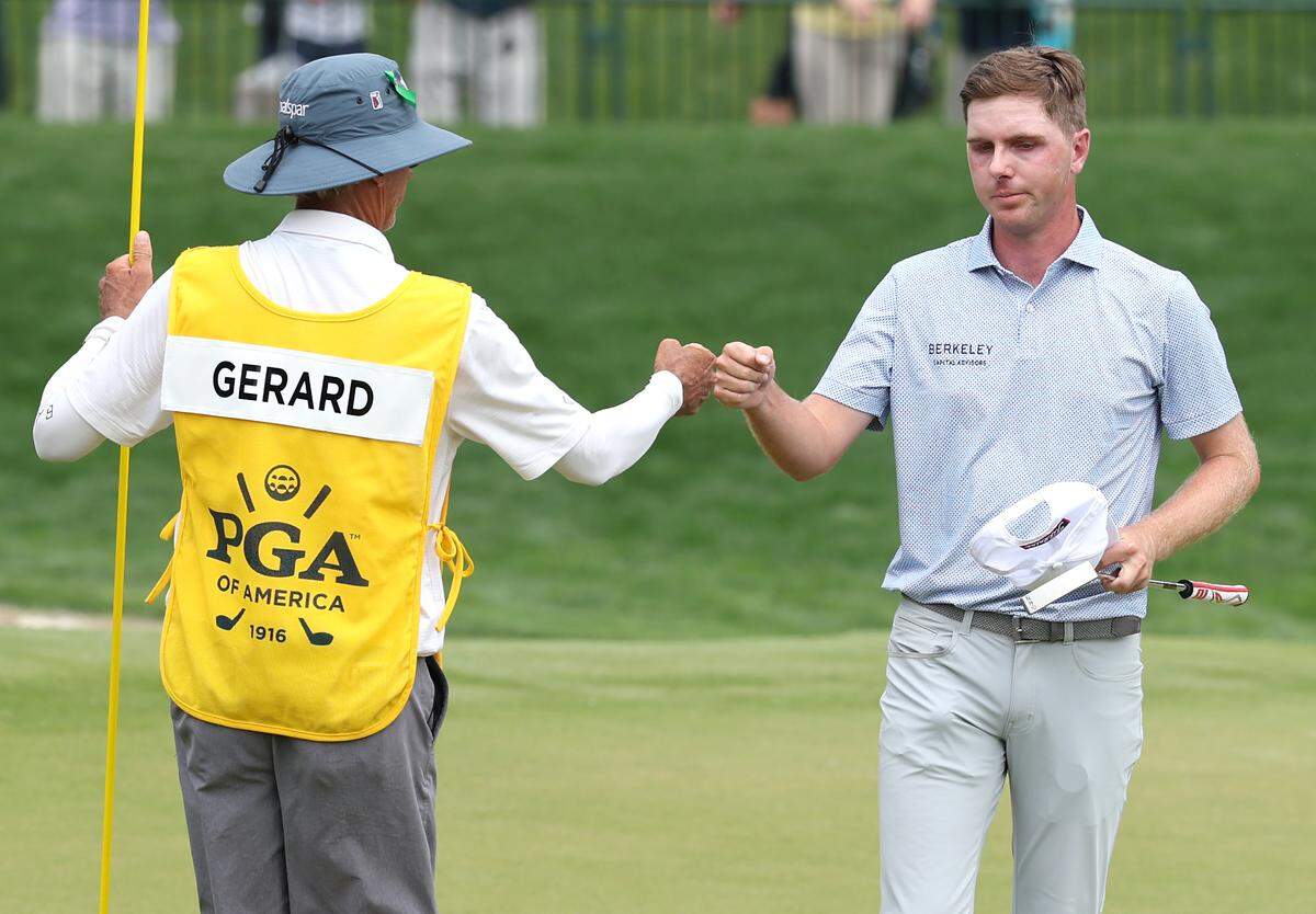 Ryan Gerard, right, and his caddie, Steven Hale, left, bump fists following completion of their opening round of the 107th PGA Championship at Quail Hollow Club in Charlotte, NC on Thursday, May 15, 2025.