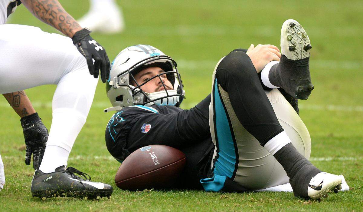 Carolina Panthers quarterback Will Grier holds onto his left leg after being sacked by New Orleans defensive end Cam Jordan on Dec. 29, 2019. The sack was the last play Grier ever participated in during a real NFL game.
