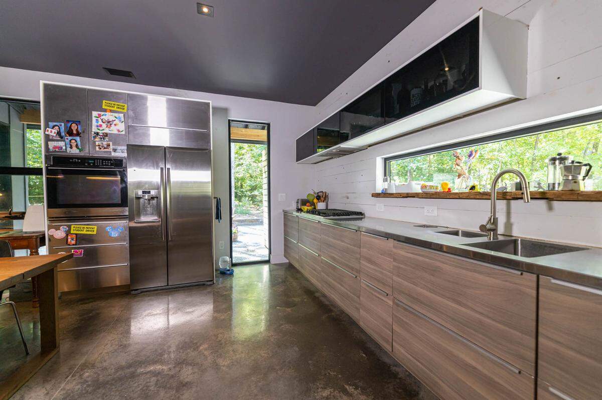 The kitchen counter includes a hole to drop compost into a bin below.