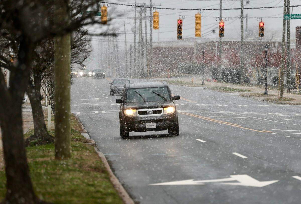 Snow starts to fall along North Graham St. in Charlotte on Wednesday, Feb. 19, 2025.