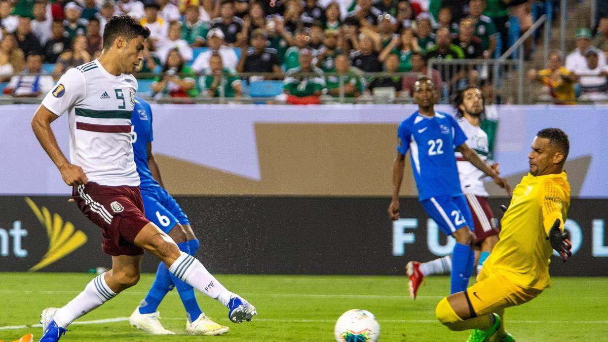 Mexico’s Raul Jimenez, left, taps the ball into the goal past Martinique goaltender Loic Chauvet during the Group A finale of the 2019 Gold Cup at Bank of America Stadium in Charlotte on Sunday.