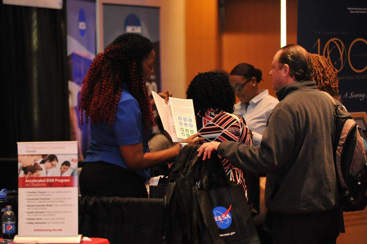 A job seeker visits the NASA table during a CIAA career expo at Charlotte Convention Center.
