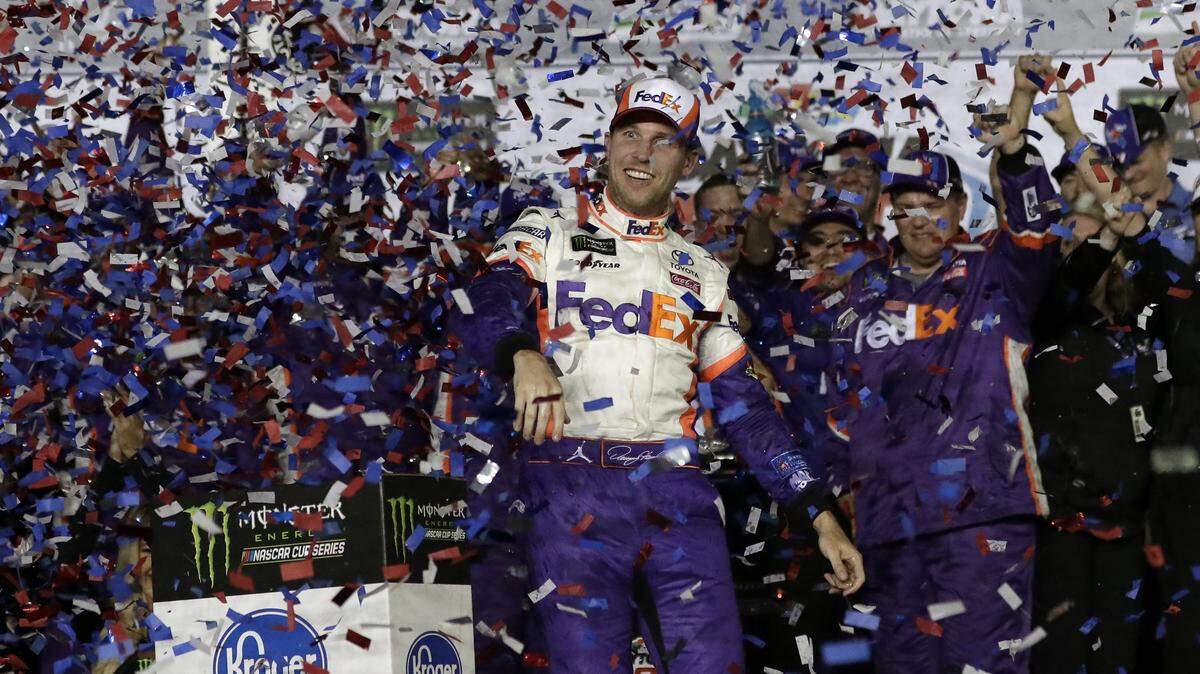 Denny Hamlin celebrates in Victory Lane after winning the NASCAR Daytona 500 at Daytona International Speedway on Sunday.
