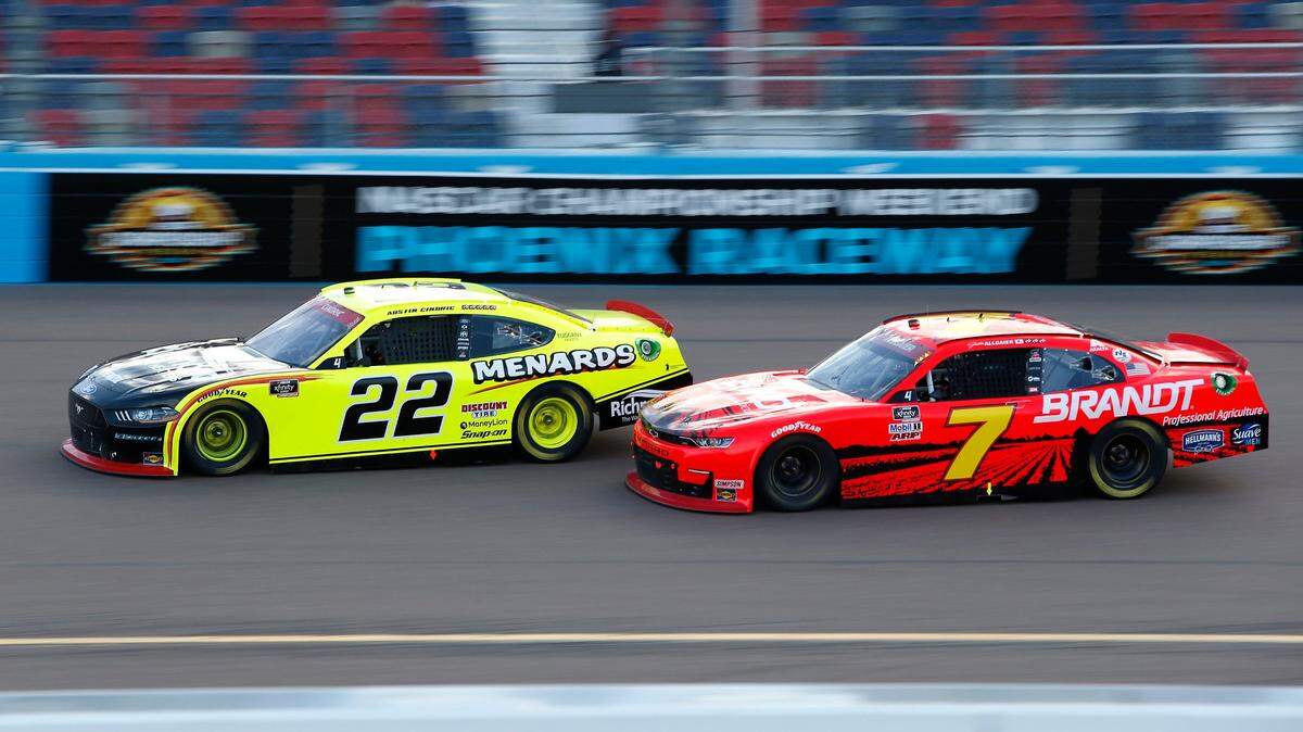 Austin Cindric (22) and Justin Allgaier (7) race for the lead through Turn 4 during a NASCAR Xfinity Series auto race at Phoenix Raceway, Saturday, Nov. 7, 2020, in Avondale, Ariz. (AP Photo/Ralph Freso)