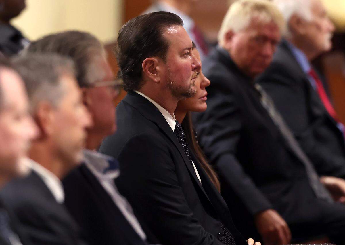 Former NASCAR driver Kurt Busch, center, attends the funeral for former longtime Charlotte Motor Speedway president H.A. “Humpy” Wheeler, Jr., on Tuesday, August 26, 2025 at St. Gabriel Catholic Church in Charlotte.