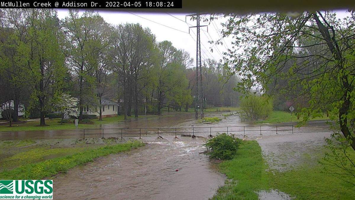 This image from a US Geological Survey webcam shows water from McMullen Creek spilling onto Addison Drive in south Charlotte, NC, as heavy rains pass through the region on Tuesday, April 5, 2022. Another round of severe weather could move through the area on Wednesday.