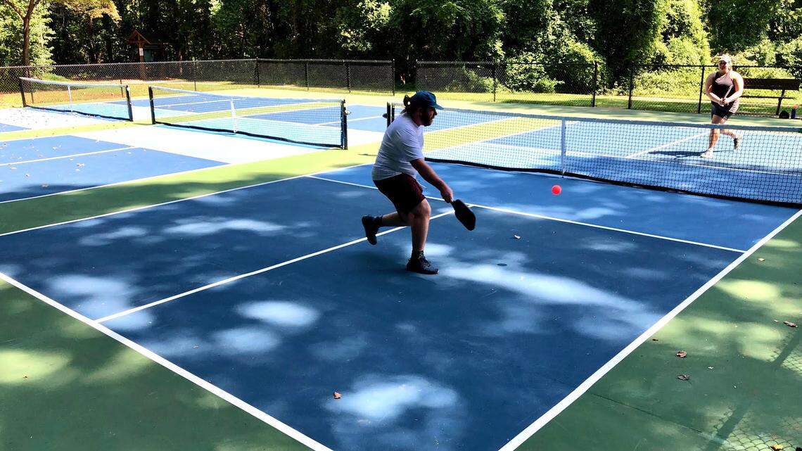 Scott Ervin, left, and Ashley Frey, right, practice on the public pickle ball courts at Sheffield Neighborhood Park in east Charlotte on Thursday, Sept. 7, 2023.