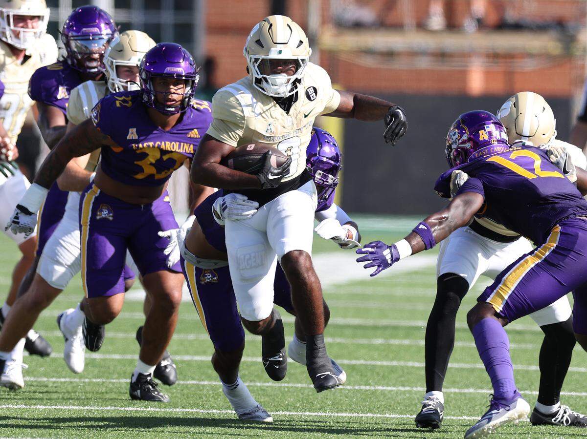 Charlotte 49ers running back Terron Kellman, center, picks up extra yardage against the East Carolina defense on Saturday.
