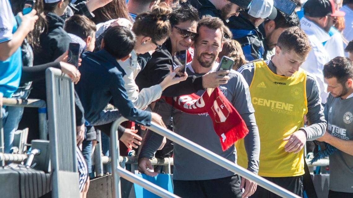 Charlotte FCs Christian Fuchs, fourth from left, poses for a selfie with a fan after an open training session at Bank of America Stadium on Thursday, February 10, 2022 in Charlotte, NC.