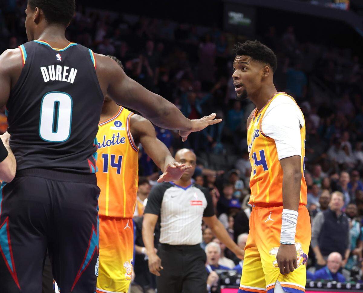 Charlotte Hornets guard Brandon Miller, right, turns to confront Detroit Pistons forward Duncan Robinson, not shown, after Robinson pushed Miller in the chest after Miller threw down a two-handed dunk during action at Spectrum Center in Charlotte, North Carolina, on Friday, April 10, 2026.
