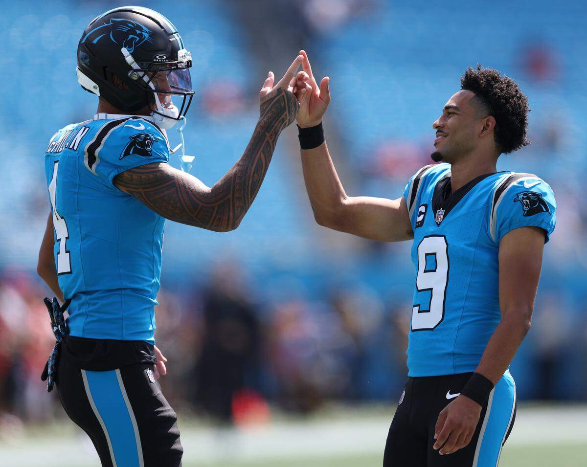 Carolina Panthers quarterback Bryce Young (9) and wide receiver Tetairoa McMillan (4) high five before the Sept. 21, 2025, game against the Atlanta Falcons.