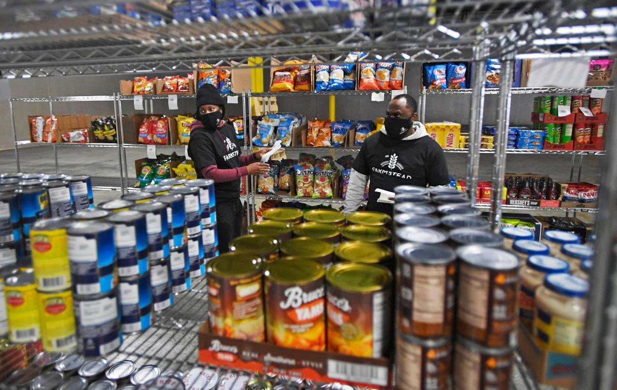 Farmstead Charlotte workers Shinesia Whatley, left, and Matthew Brown tag grocery items on the shelves at the offices on Thursday, November 19, 2020. This is the first expansion of the Silicon Valley online grocer into the Charlotte market and East Coast.