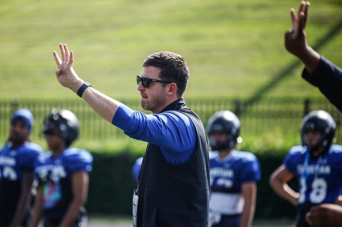 Charlotte Christian head coach Chris James holds up a signal during football practice on Wednesday, August 22, 2024.