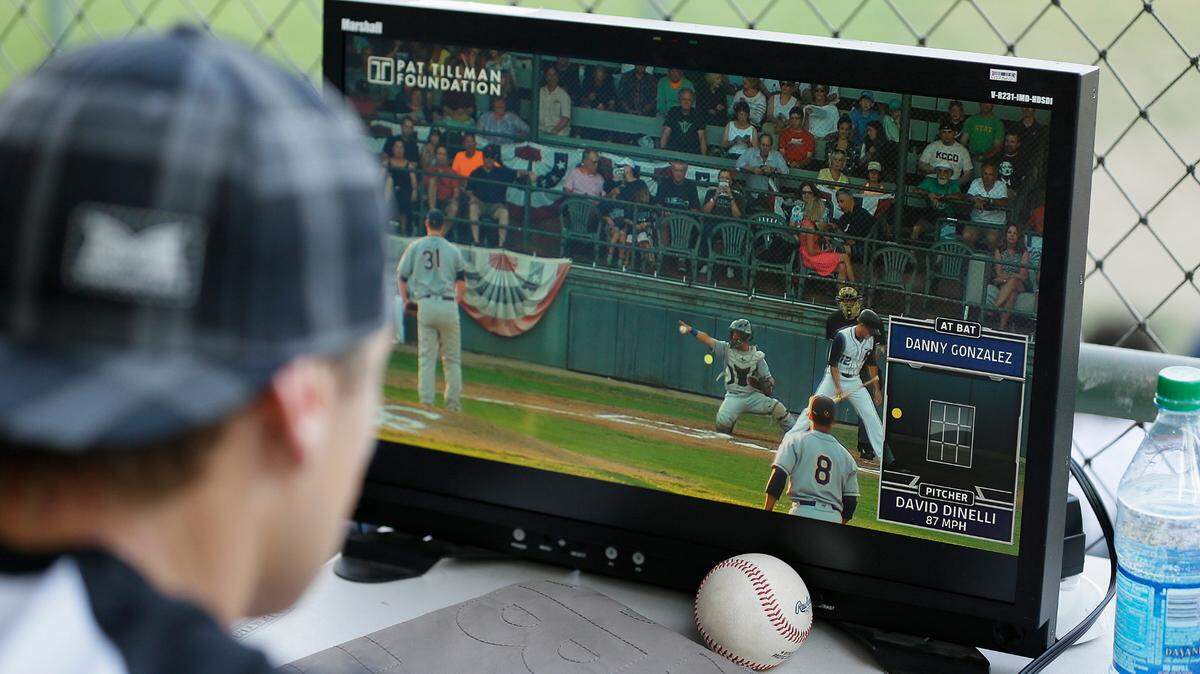 Former major league outfielder Eric Byrnes uses a computerized video system to call balls and strikes at an independent minor league baseball game between the San Rafael Pacifics and Vallejo Admirals in 2015 in San Rafael, California. (AP Photo/Eric Risberg)