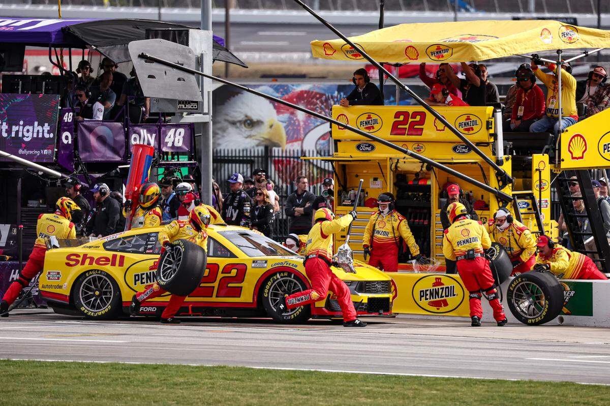 Joey Logano (22) gets pit service during the NASCAR Cup Series’ Ambetter Health 400 at Atlanta Motor Speedway on Sunday.