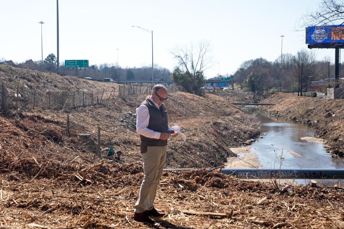 Vince Chelena stands in near a clear-cut creek bank off of Interstate 77.