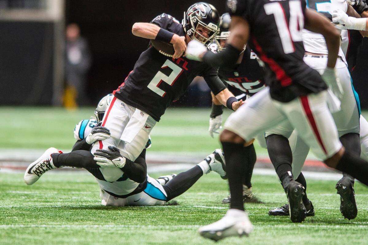 Panthers outside linebacker Haason Reddick, bottom center, sacks Falcons quarterback Matt Ryan, center, during the game at Mercedes-Benz Stadium on Sunday, October 31, 2021 in Atlanta, GA.