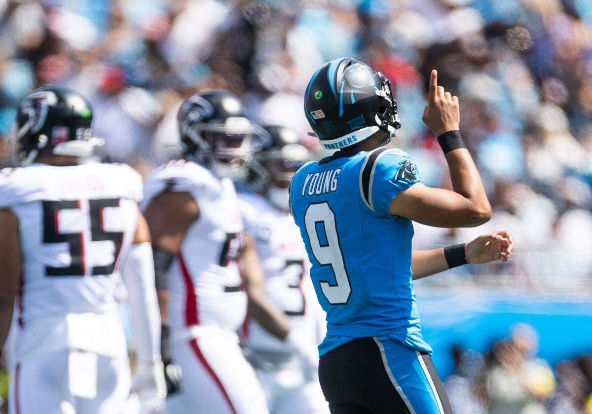 Carolina Panthers quarterback Bryce Young points to the sky after a play against the Atlanta Falcons on Sunday at Bank of America Stadium in Charlotte on Sunday, Sept. 21, 2025